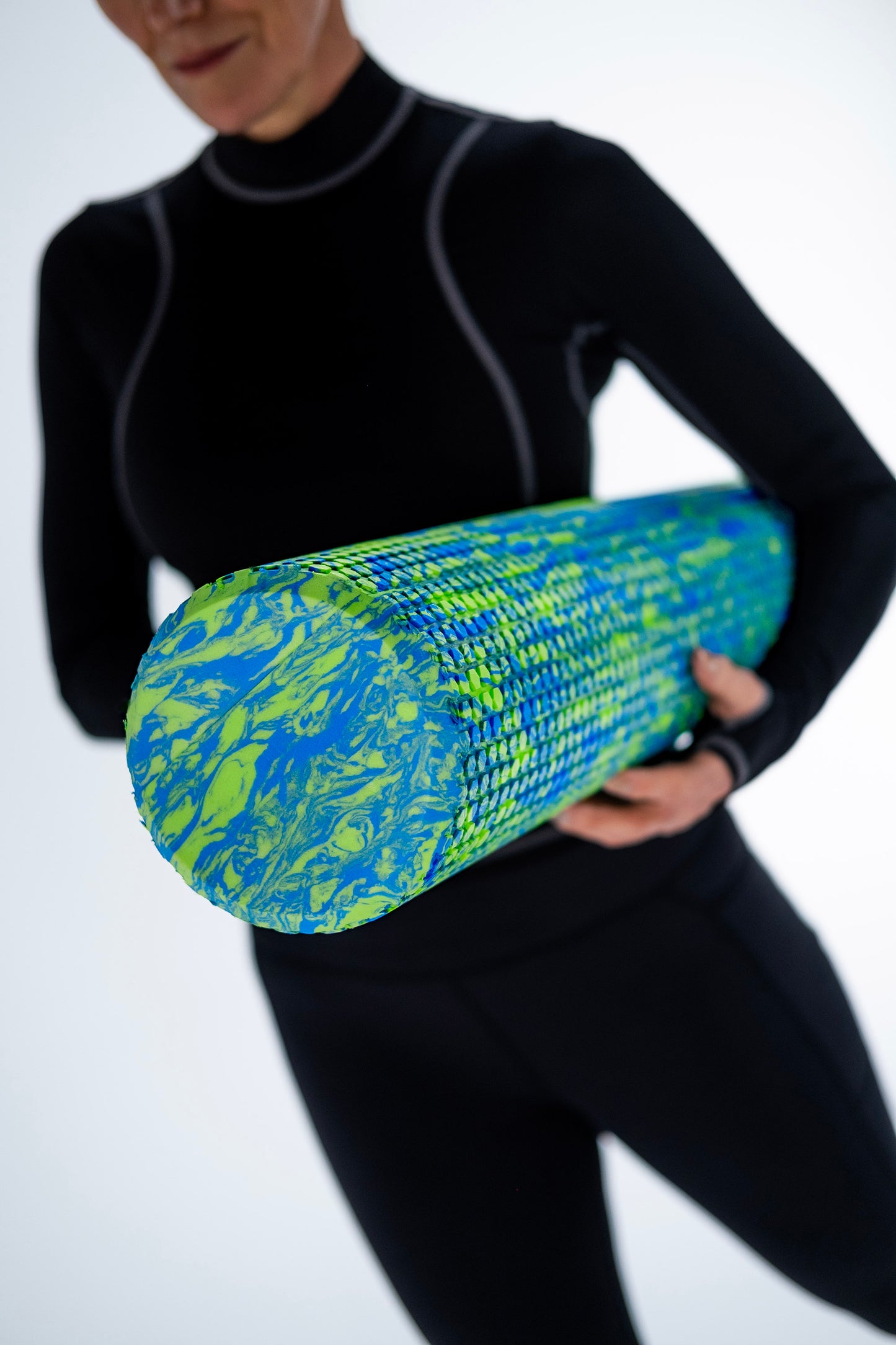 pilates roller being held in arms